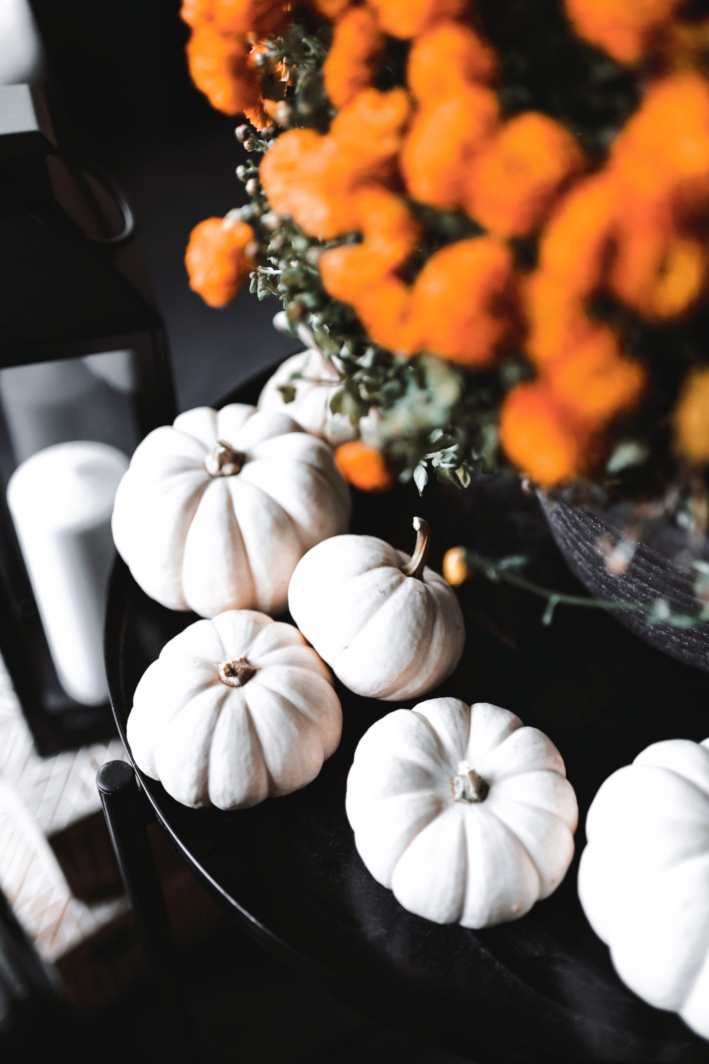 Fall decor, small white pumpkins, candles in background