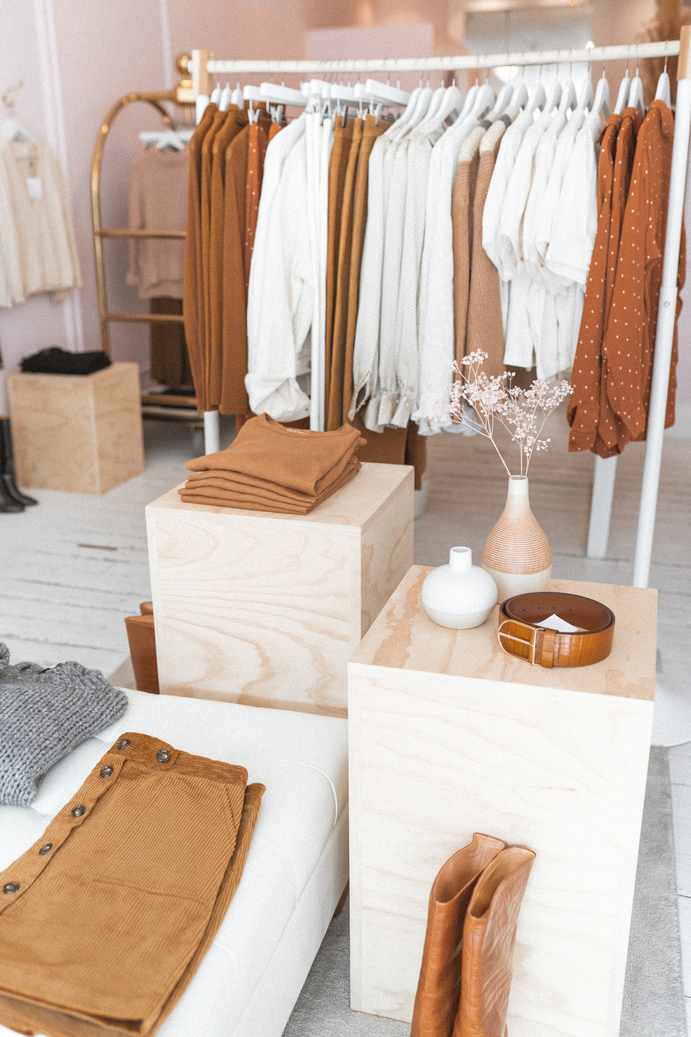 Store setting with fall colored clothing, warm tones