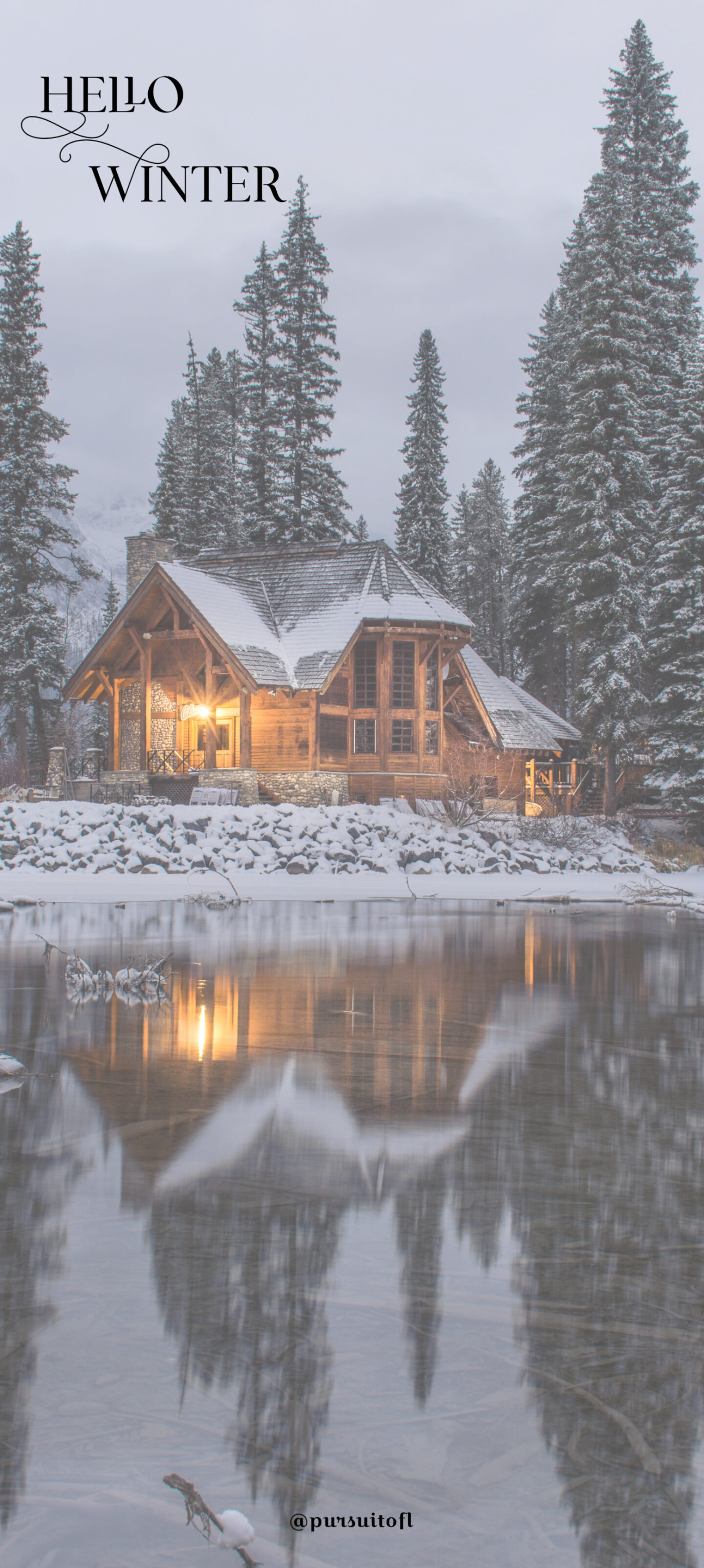 Winter phone wallpaper with log cabin on a lake in a snowy forest with hello winter text