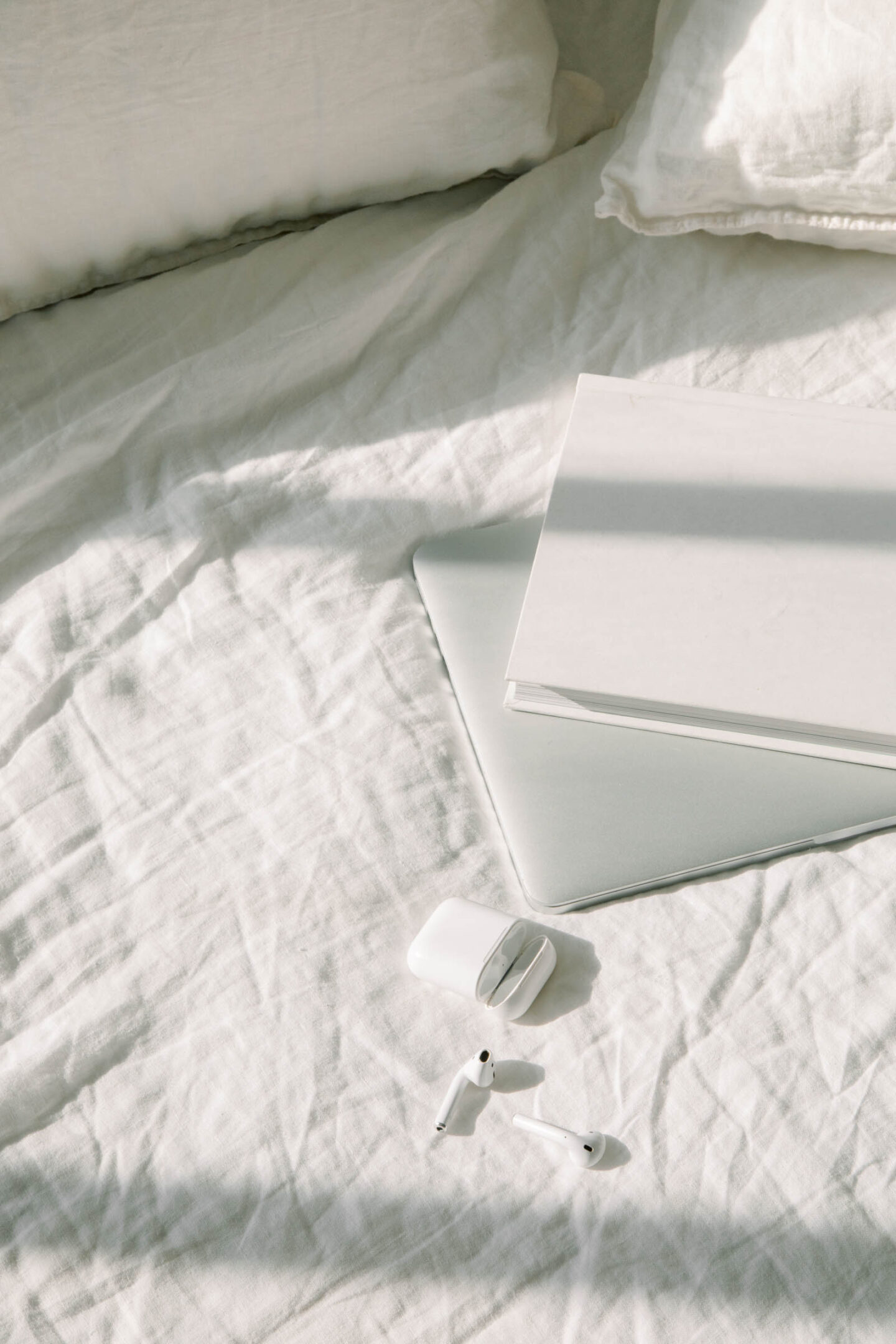 Bed flatly with laptop, notebook and AirPods; 12 Days of Blogmas | Setting Up for an Amazing First Quarter; The Pursuit of L