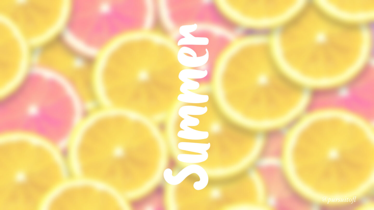 Blurred desktop wallpaper with pink and yellow lemons and white summer text