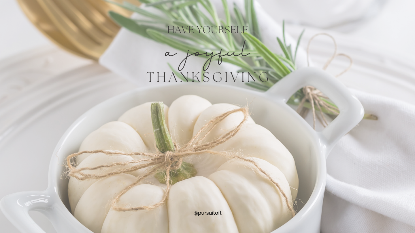 A minimalist desktop wallpaper featuring a white mini pumpkin tied with a twine bow, placed on a neutral plate setting with the message 'Have Yourself a Joyful Thanksgiving' in elegant lettering.